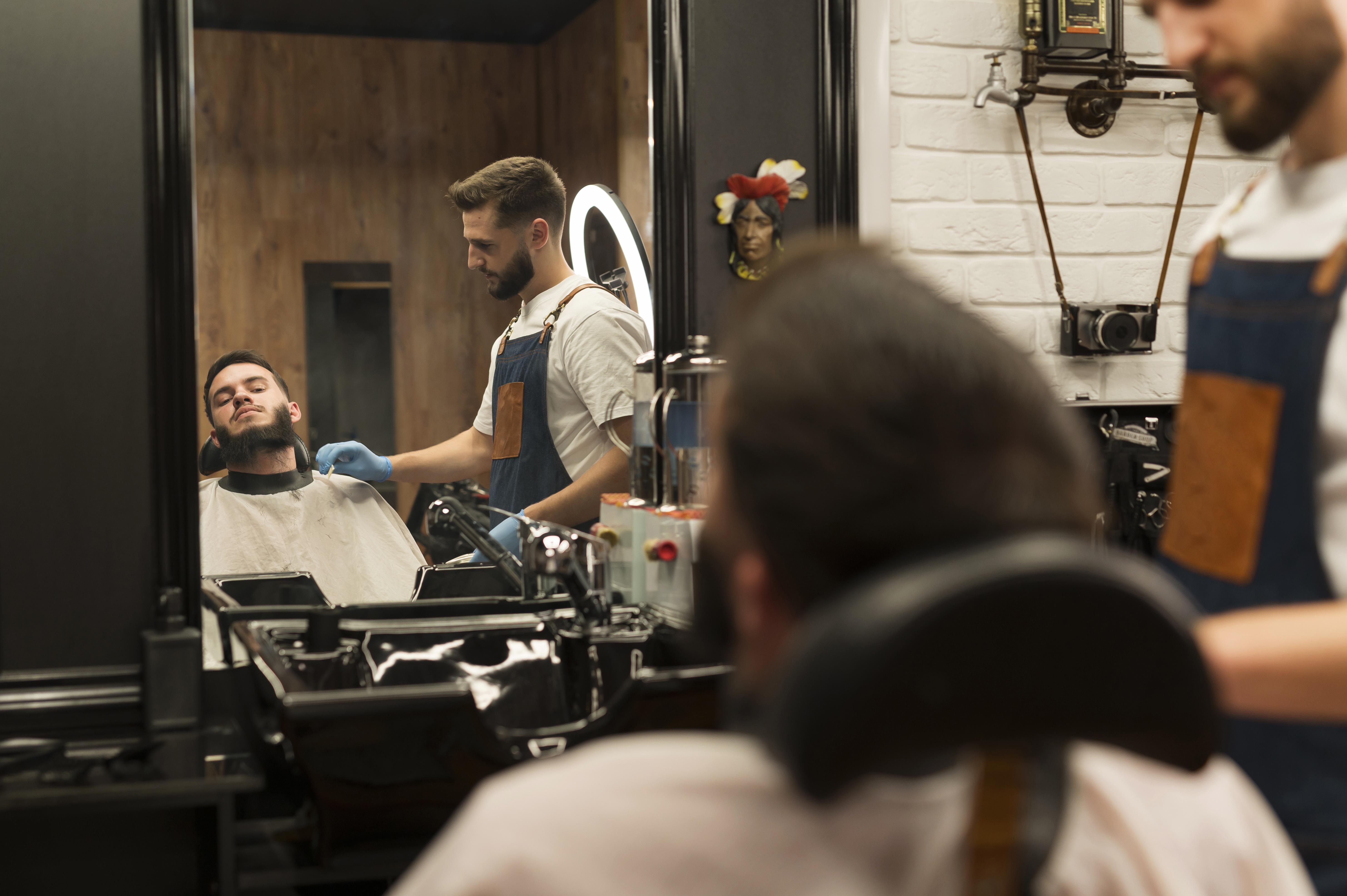 young-man-getting-his-beard-styled-barber